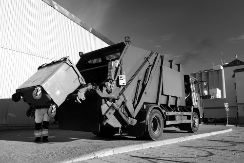 Environmental recycling symbol with a skip in the background