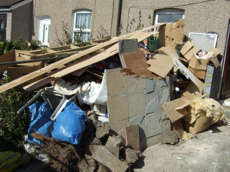 A mini skip placed in a residential Hammersmith garden